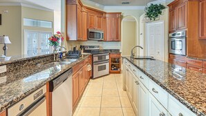 A kitchen with granite countertops, wooden cabinets, stainless steel appliances, and a built-in oven. - Pool & Lanai! Sophisticated Spring Hill Stay (Spring Hill)