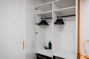 A white wardrobe with hanging space and a shelf. - Cannes Port | Suite 2 | Vue imprenable Palais (Cannes)