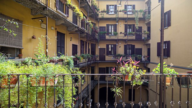 A multi-story building with balconies, some with plants. - Italianway Comfort - Sottocorno 17 (Milan)