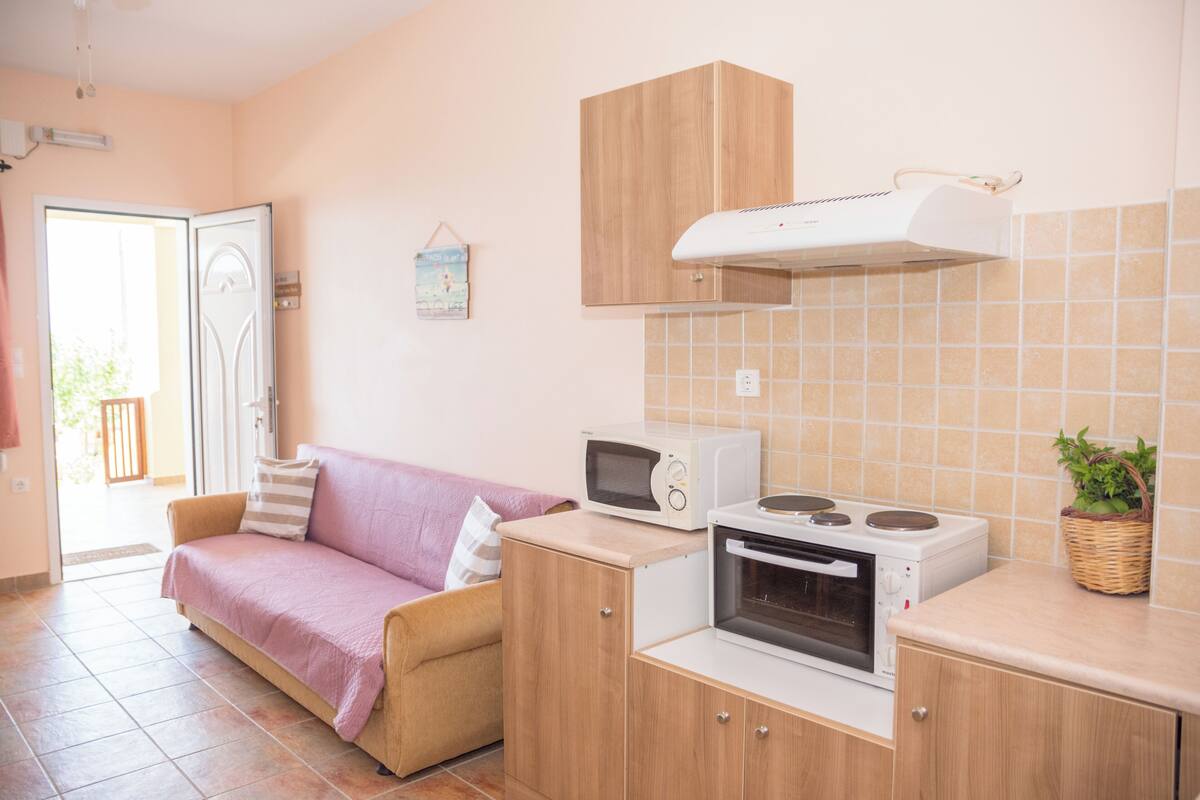 A compact kitchen with a microwave, oven, and a small countertop.