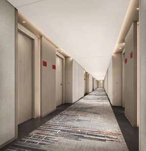 A hotel corridor with a patterned carpet, wooden panel walls, and doors with red signage. - Hyatt Place Jiaxing Nanhu (Jiaxing)