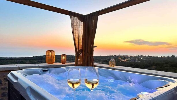 A hot tub with two glasses of wine, a sunset view, and decorative lanterns. - Armantanis Luxury Suites (Areopoli)