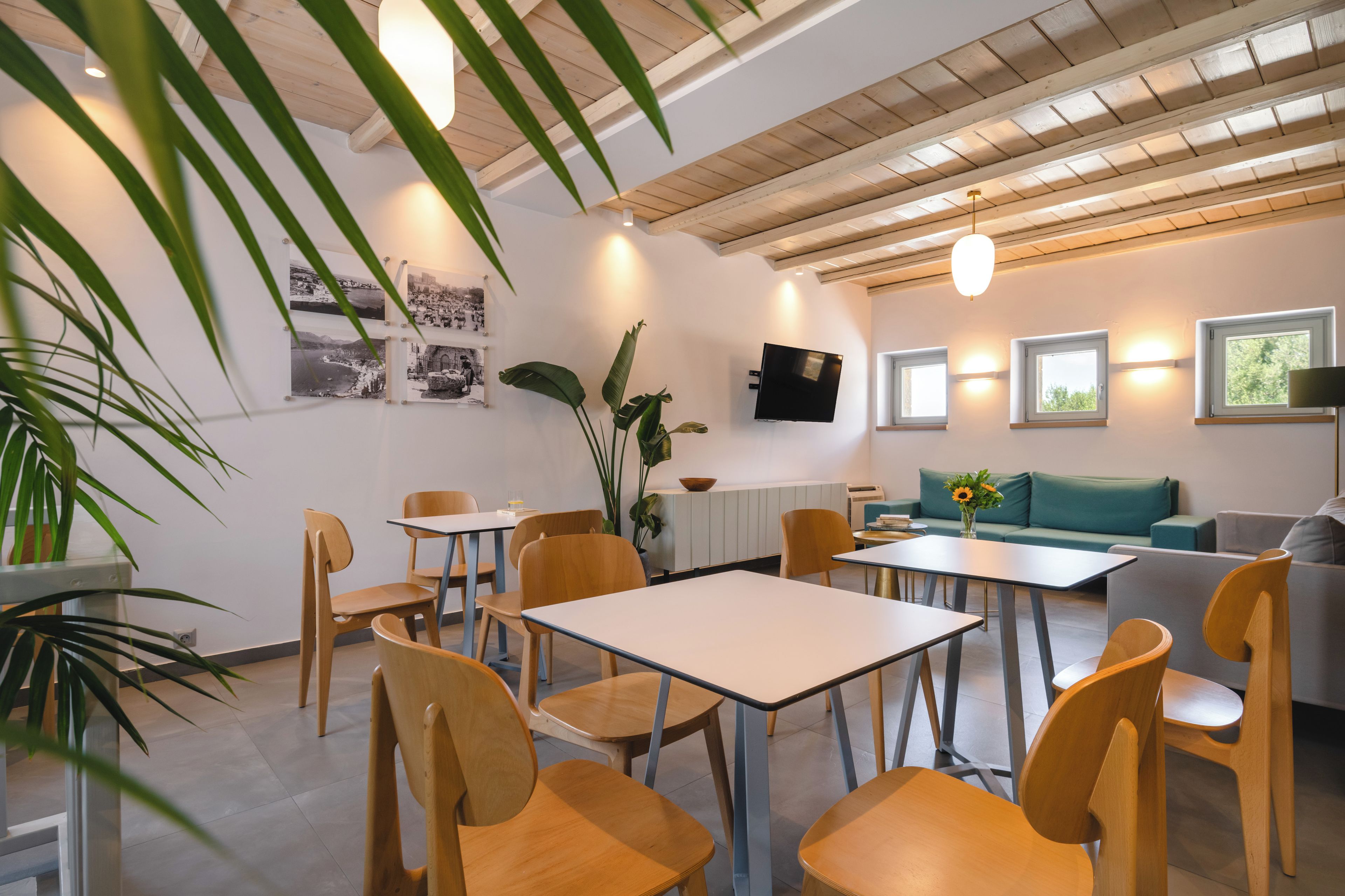 A modern interior with wooden furniture, a flat-screen TV, and a dining area.