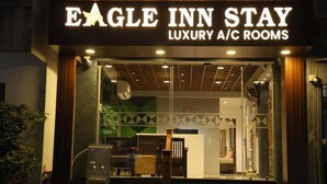 The exterior of Eagle Inn Stay, a luxury A/C room establishment.