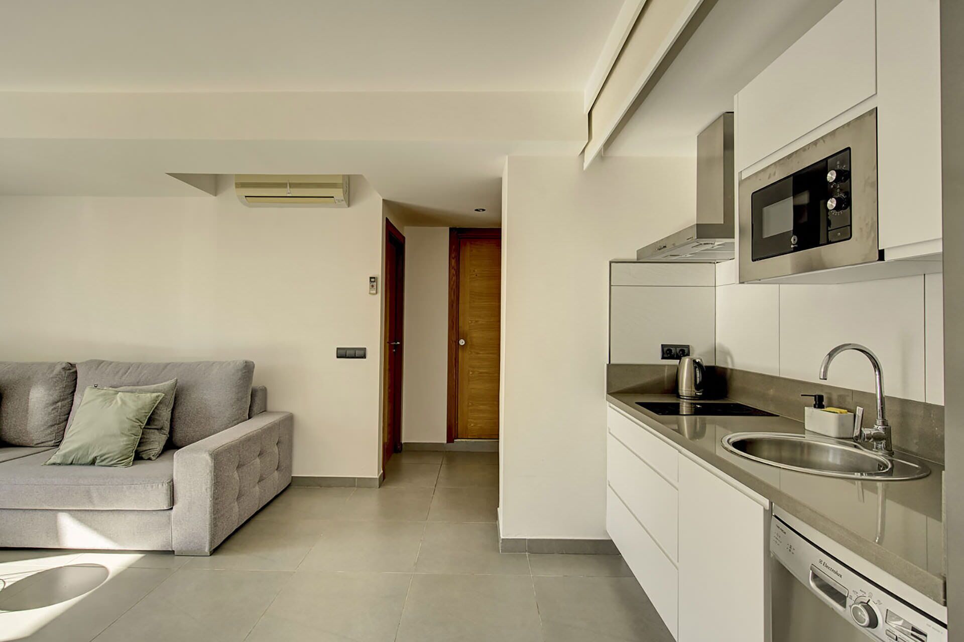 A modern kitchen with stainless steel appliances, a built-in microwave, and a dishwasher.