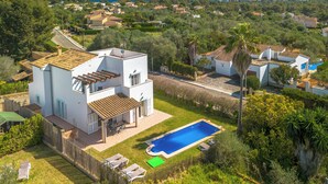 A modern villa with a swimming pool, surrounded by lush greenery and a clear view of the sea. - Son Ganxo I by Interhome (Cala Murada)
