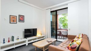A modern living room with a TV, sofa, and coffee table. - Trendy Teneriffe! ~ 1Bed, 1Bath, 1Car, Balconies (Teneriffe)