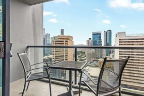 A balcony with two chairs and a table, offering a city view. - City Centre! 1Bed/1Bath/Study/1Car/Balcony ~ CBD (Brisbane City)