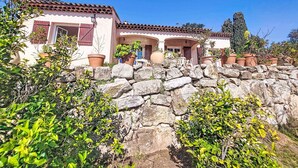 A traditional building with a stone wall, terracotta roof tiles, and potted plants. - L´Argentière by Interhome (Les Adrets)