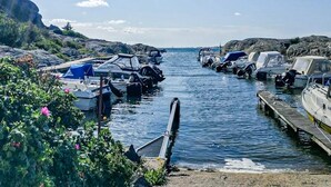 A marina with boats docked, calm water, and rocky terrain. - 4 Star Holiday Home in Karna (Kärna)