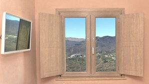A room with a large window, a radiator, and a wall-mounted TV. - Tourist Accommodation Rainbow "Apartment Superior" (Roccavivara)