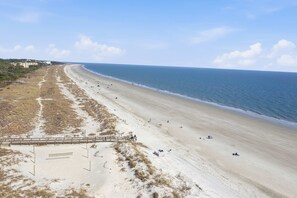 A beach with a wooden walkway and a few people. - Tennis Villa G6 - 2BR Beach Retreat Walk to Beach (Hilton Head Island)