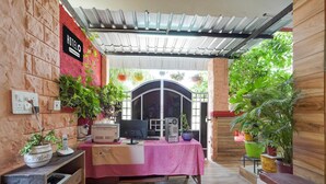 A hotel reception area with a desk, computer, and various potted plants. - Premiumjannat Residency (Jodhpur)