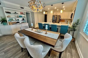 A modern kitchen with white cabinets, a central island, and pendant lighting. - PAC 201...Great Ocean View, 2nd floor 2BR/2BA condo overlooks lagoon (Saint Augustine)