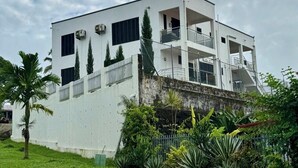 A modern two-story building with a flat roof, large windows, and a balcony on the upper floor. - 1 Bedroom Apartment in Namadi Height, SUVA (Suva)