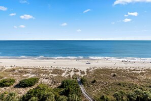 A beach with a wooden boardwalk leading to the shore, sandy beach, and ocean. - Salt & Seat Stunning Oceanfront Condo at Beach Colony Resort! (Myrtle Beach)