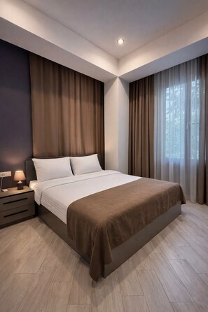 A modern bedroom with a large bed, a bedside table with a lamp, and a window with curtains. - Fama 12 Hotel (Yerevan)
