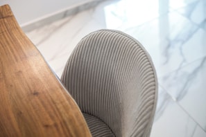 A close-up of a wooden chair with a ribbed seat and backrest. - Dorians Faliraki (Faliraki)