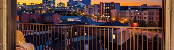A cityscape at dusk with buildings and a balcony. - Rooftop Deck Skyline Views Downtown Penthouse (Nashville)