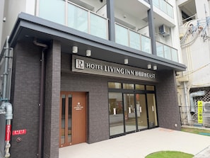 A hotel entrance with a sign reading 'Hotel Living Inn' and a visible 'R' indicating room availability. - Hotel Living Inn Asahibashiekimae EAST (Naha)