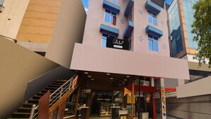 A modern building with a sign reading 'Collection & Company Services.' - Single Roomsixmile Guwahati (Guwahati)
