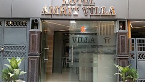 The entrance to Hotel Amrit Villa with a modern design, featuring a glass facade and a prominent sign. - Hotel Amrit Villa Karol Bagh New Delhi (New Delhi)