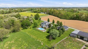 A large house with a swimming pool, surrounded by green lawns and trees. - Northern Kentucky Gem w/ Yard & In-ground Pool! (California)