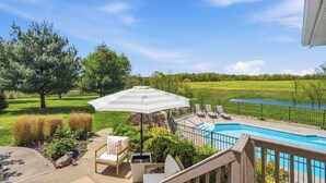 A backyard with a pool, outdoor furniture, and a view of a golf course. - Northern Kentucky Gem w/ Yard & In-ground Pool! (California)