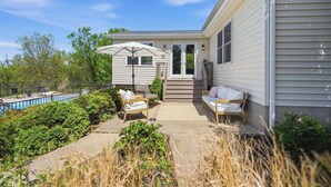 A residential property with a swimming pool, outdoor seating, and a covered patio area. - Northern Kentucky Gem w/ Yard & In-ground Pool! (California)
