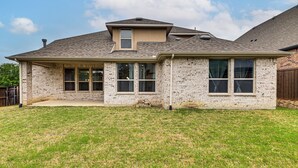 A single-story house with a brick exterior, a gabled roof, and a front porch. - Near Lake & Family Fun! Spacious Oak Point Home (Little Elm)