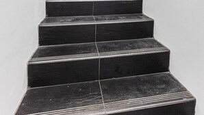 A staircase with a handrail on one side and a door at the top. - 4BR Carlisle Stay Near Airport & Stadium  Sleeps 8 (Carlisle)