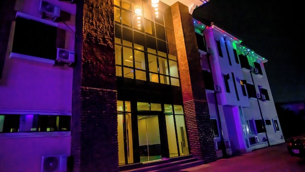 A multi-story building with large windows, air conditioning units, and a modern architectural design. - Orison Hotel (Owerri)