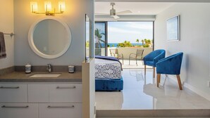 A modern bathroom with a round mirror, dual sinks, and a large window offering a view of the ocean. - Walk to Beach Modern Oceanview Villa w/ 2 Pools, Hot Tub & Concierge Cabo (Cabo San Lucas)