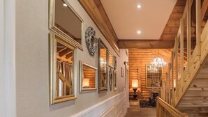 A hallway with wooden paneling, a staircase, and a chandelier. - Quba Palace Hotel & Golf Resort (Quba)