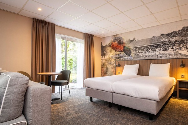 Unwind in a bright room with plush beds and garden light.