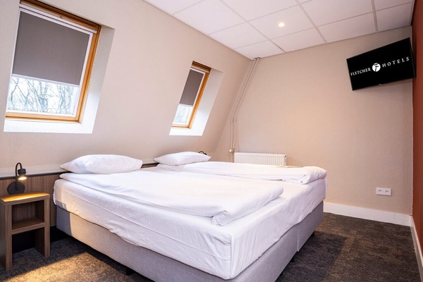 Recharge in a snug, quiet bedroom tucked under cozy skylights.