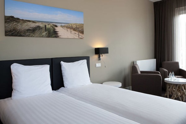 Sink into crisp twin beds after a day of exploring.