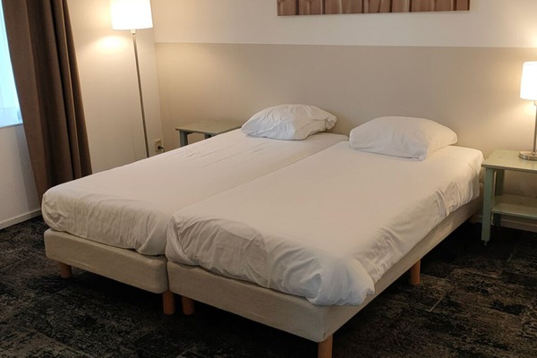 Drift off in a simple room designed for restful nights.