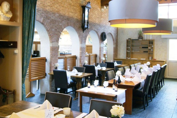 Enjoy relaxed dining beneath rustic arches and soft glow.