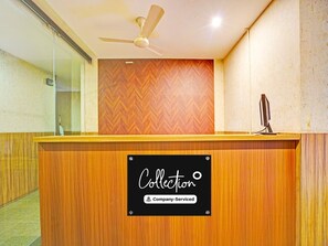 A reception desk with a sign reading 'Collection Company-Serviced'.