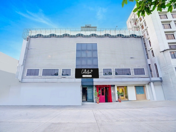 A modern building with a large sign reading 'Collection.'