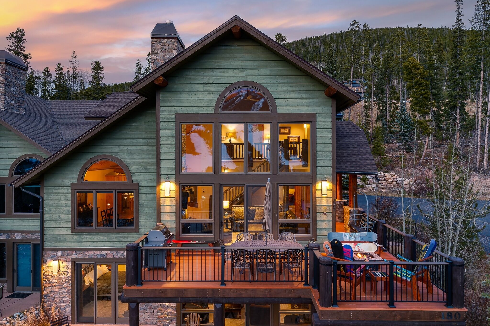 A large wooden house with multiple windows and a deck.