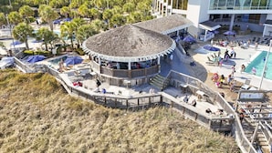 A resort with a central circular building, a pool area, and surrounding greenery. - 2002p 2 Bedroom Condo (Myrtle Beach)