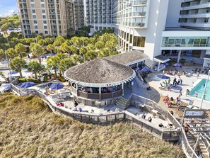 A resort with a central circular building, a pool area, and surrounding greenery. - 2002p 2 Bedroom Condo (Myrtle Beach)