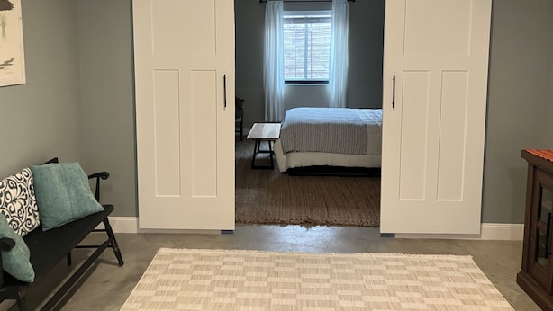 A bedroom with a bed, a window with curtains, a desk, and a chair. - Eagles Nest in the village of Geneseo (Geneseo)