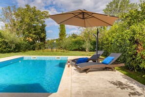 A swimming pool with lounge chairs and an umbrella. - Villa STOCK 66 - Charming villa with private pool (Stokovci)