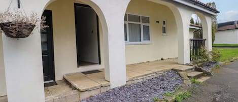 A house with a porch, a door, and a window.