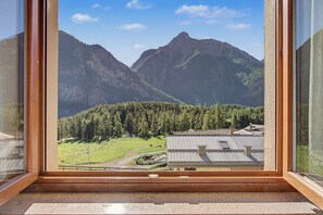 A mountain view through a window with a wooden frame. - "Room 7" with Mountain View and Shared Terrace in Bionaz (Dzovennoz)