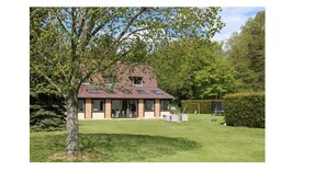 A house with a brick exterior, large windows, and a grassy yard. - Charming family home in Normandy (Chamblac)
