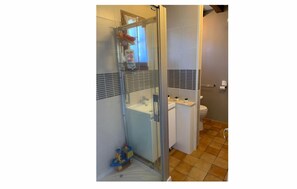 Shower, hair dryer, soap, toilet paper